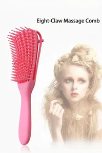 Close-up of pink eight-claw massage brush for detangling hair and scalp care