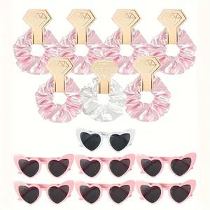 Detail of 14-piece party set with pink heart sunglasses and satin scrunchies