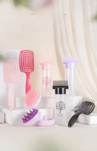 Detail view of pink scalp massage brush and hair care applicator bottles on display stands