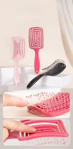 Close-up of flexible hair brush with soft massage bristles and curved hollow back design