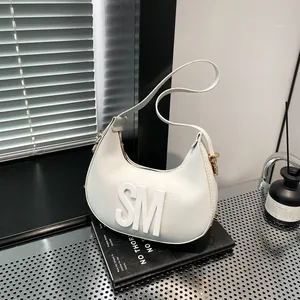 Minimalist white crescent shoulder bag with 3D SM logo and textured synthetic leather