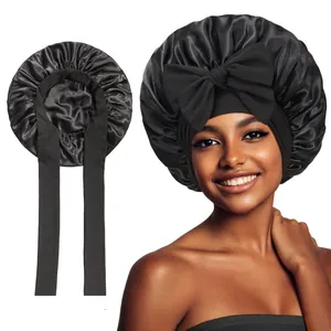 Detailed view of black satin hair bonnet featuring a large decorative bow and wide band