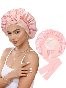 Détail du bonnet de nuit en satin rose avec large ruban et texture soie élastique