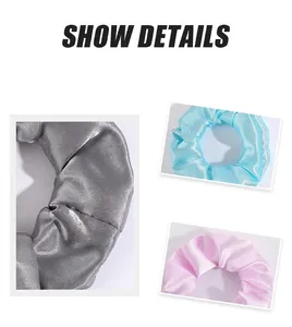 Détails des chouchous en satin argent, bleu et rose avec une texture soyeuse