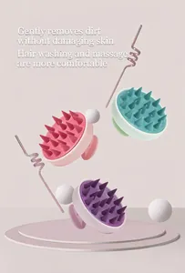 Macro view of silicone scalp massage brushes in pink, green and purple colors