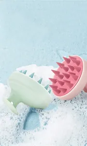 Close-up of pink and green silicone scalp massagers with soft bristles for deep cleaning