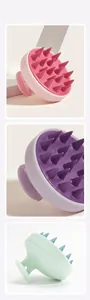 Detailed view of silicone scalp massage brushes in pink, purple, and green colors