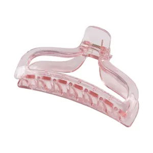 Close-up of translucent pink shark hair claw clip with streamlined design and metal spring