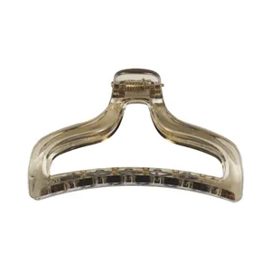 Detail of translucent brown shark hair claw clip with golden spring and AK-078 engraving
