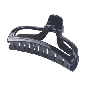 Close-up of a glossy black geometric hair claw clip for thick hair styling on white background