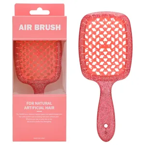 Dettaglio spazzola rosa glitterata con design a nido d'ape e confezione regalo