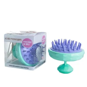 Spazzola massaggiante per cuoio capelluto con punte in silicone viola e base verde in scatola