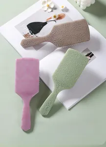 Detail of square cushion hairbrushes with vintage floral relief and flexible white bristles