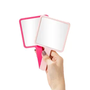 Handheld square makeup mirrors in pink and rose red with ergonomic handles