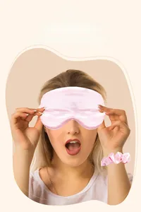 Pink silk satin sleep mask and scrunchie set shown on a model for soft comfort