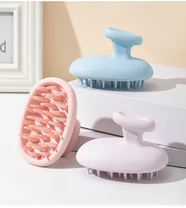 Macro view of blue, pink, and purple silicone scalp massagers with ergonomic handles