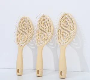 Macro detail of vented hollow hairbrushes in beige with massage tips and hanging hole