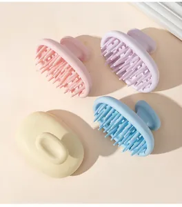 Top view of four colorful silicone scalp massage brushes with ergonomic ring handles