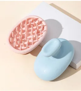 Detail view of pink and blue silicone scalp massagers with ergonomic handles