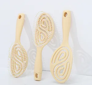 Detailed view of hollow spiral vent brush for hair styling and scalp massage in beige