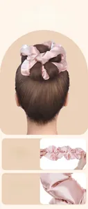 Detail of pink satin hair scrunchie showing high elasticity and smooth fabric texture
