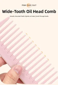 Macro detail of a pink wide-tooth comb showing smooth rounded teeth for scalp protection