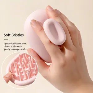 Pink silicone scalp massager brush with ergonomic handle for hair cleaning and massage