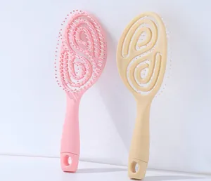 Detail of hollow spiral design on pink and beige flexible massage hairbrushes