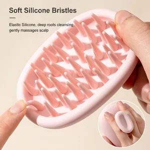 Soft pink silicone scalp massager brush for hair washing with non-slip handle grip