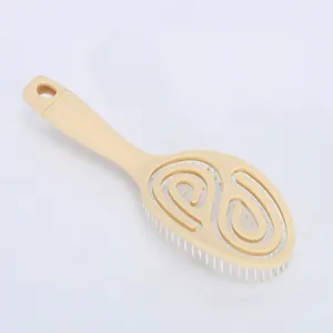 Beige oval vented hair brush with a spiral open design for fast blow-drying and styling