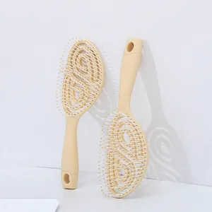 Ergonomic vented oval hairbrush in beige for wet hair styling and blow-drying