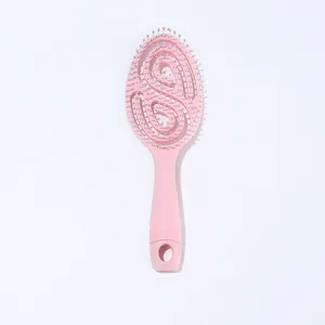 Professional pink curved vented hairbrush with hollow S-shaped design for fast blow-drying