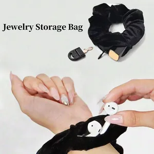 Detail of black velvet scrunchie with hidden zipper pocket for keys and small items