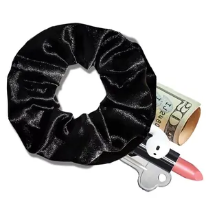 Detail view of black velvet hair scrunchie with hidden zipper pocket for small items