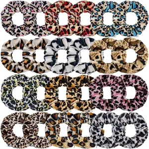 Flat lay of 24 pieces leopard print velvet scrunchies in various colorful patterns