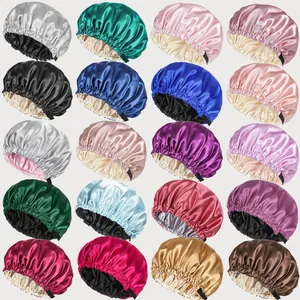 Detail showing various colors of double-layer satin sleep bonnets with adjustable buttons