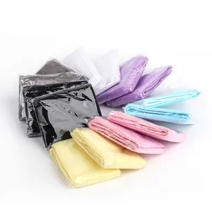 Detailed stack of colorful microfiber spa headbands in individual plastic packaging bags