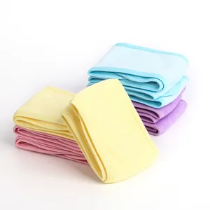 Close-up of soft coral fleece headbands in pastel blue, yellow, pink, and purple colors