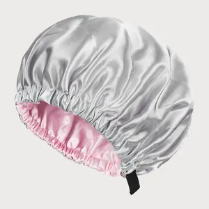 Detail view of double-layer satin bonnet with adjustable strap and pink lining