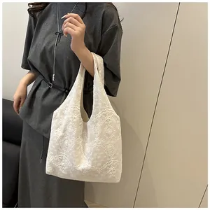 Detail of white lace embroidery texture on a floral tote bag for casual everyday use