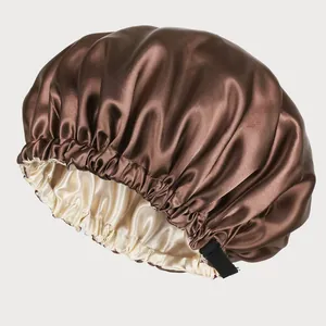 Detail of double-layered satin bonnet with adjustable strap and contrast champagne lining