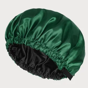 Detail of the double-layered satin hair bonnet showing the dark green silk texture and elastic band