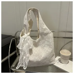 Close-up of white floral lace tote bag featuring a large bow and sweet vintage style