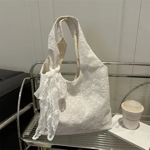 Elegant cream lace tote bag with floral patterns and a large decorative bow for women