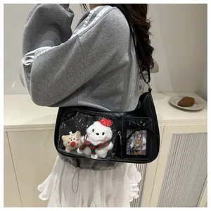 Detail of black leather Ita bag featuring transparent window with white puppy plush decor