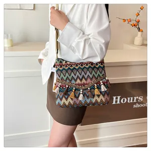 Close-up of Bohemian woven crossbody bag with colorful patterns and tassel details