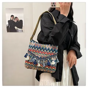 Detail of colorful bohemian woven crossbody bag featuring wave texture and long fringe