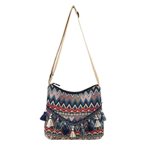 Ethnic bohemian woven crossbody bag with colorful zigzag patterns and fringe details