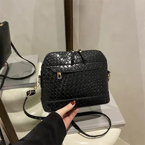 Chic black woven texture crossbody bag with gold hardware and wide shoulder strap