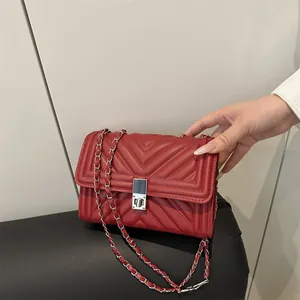 Quilted red leather shoulder bag with silver chain strap and metal turn-lock closure